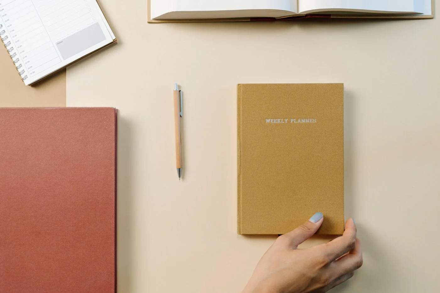 Planning notebooks and a pen on a desk. Illustrative photograph, not documentation of an AI tool test. cottonbro studio / Pexels, Pexels License.